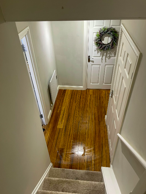 Freshly finished hallway with painted white door and staircase — interior decorating by MNC Construction, Billericay, Essex